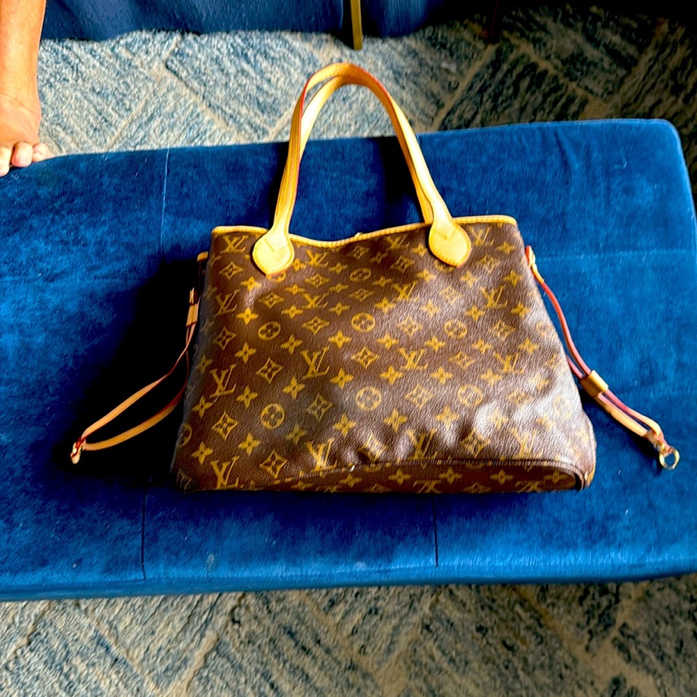Louis Vuitton authentic never full tote with authenticity card. Like new!